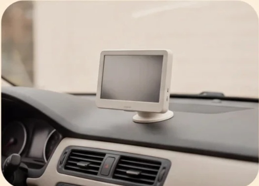 Monitor secured to its mount on a car dashboard