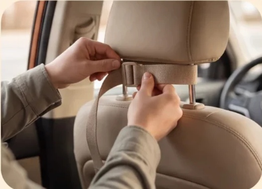 Fastening the camera strap around a car headrest